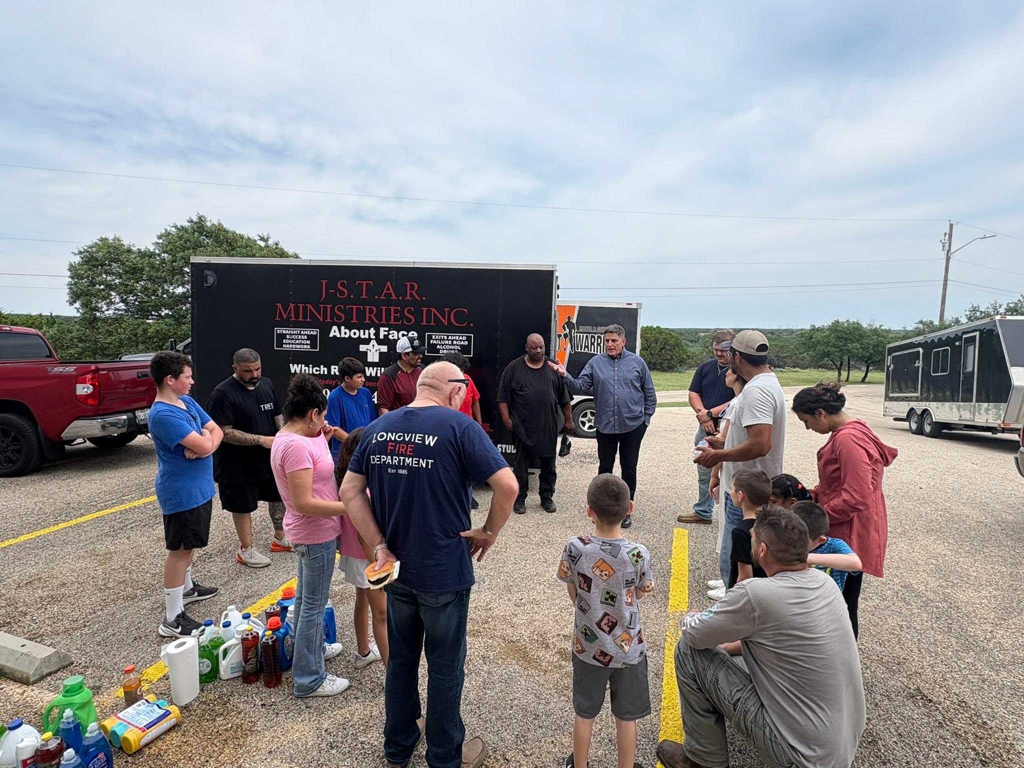 Community members gathered beside relief trailers and donated supplies during the Kerrville trip.