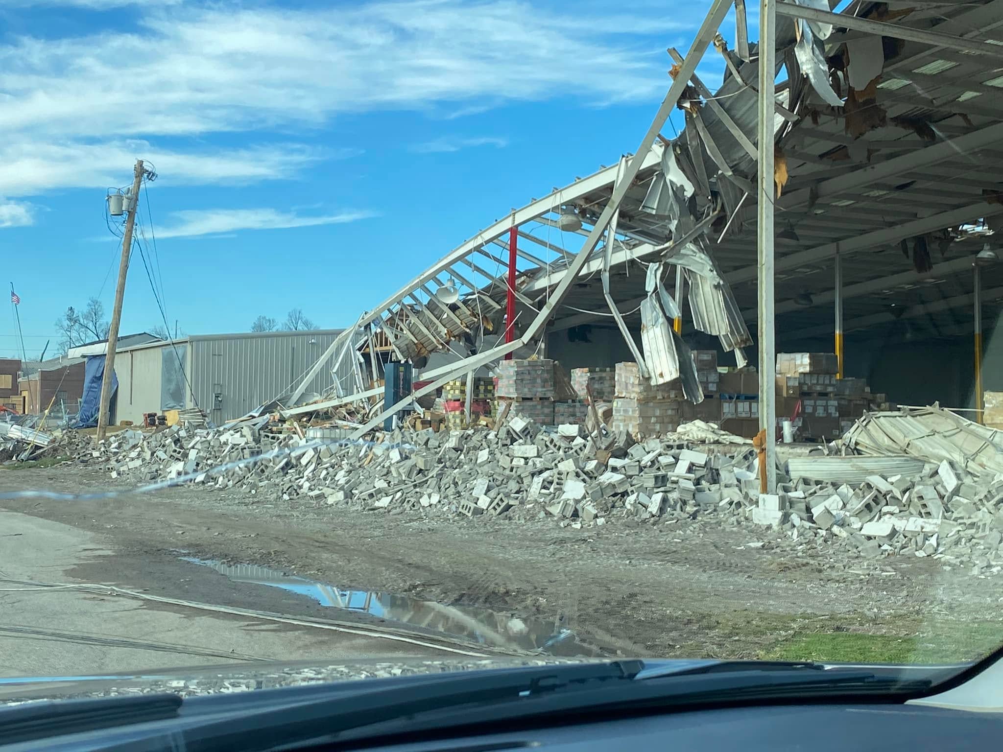 Tornado-damaged warehouse with collapsed walls and roof panels in Patrick's December 21 Mayfield album.