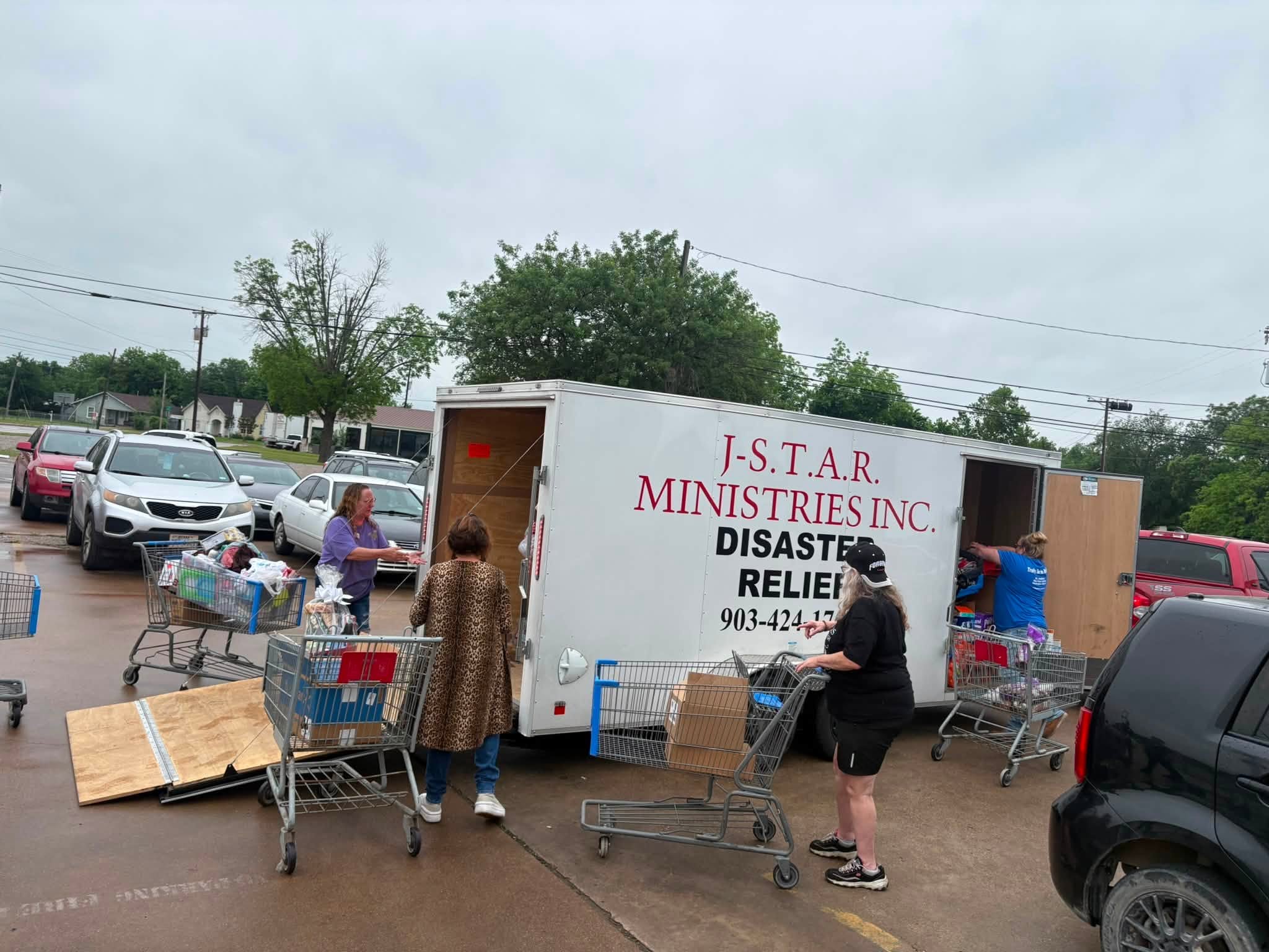 Helpers unload supplies from the J-STAR Ministries disaster relief trailer in Mineral Wells.