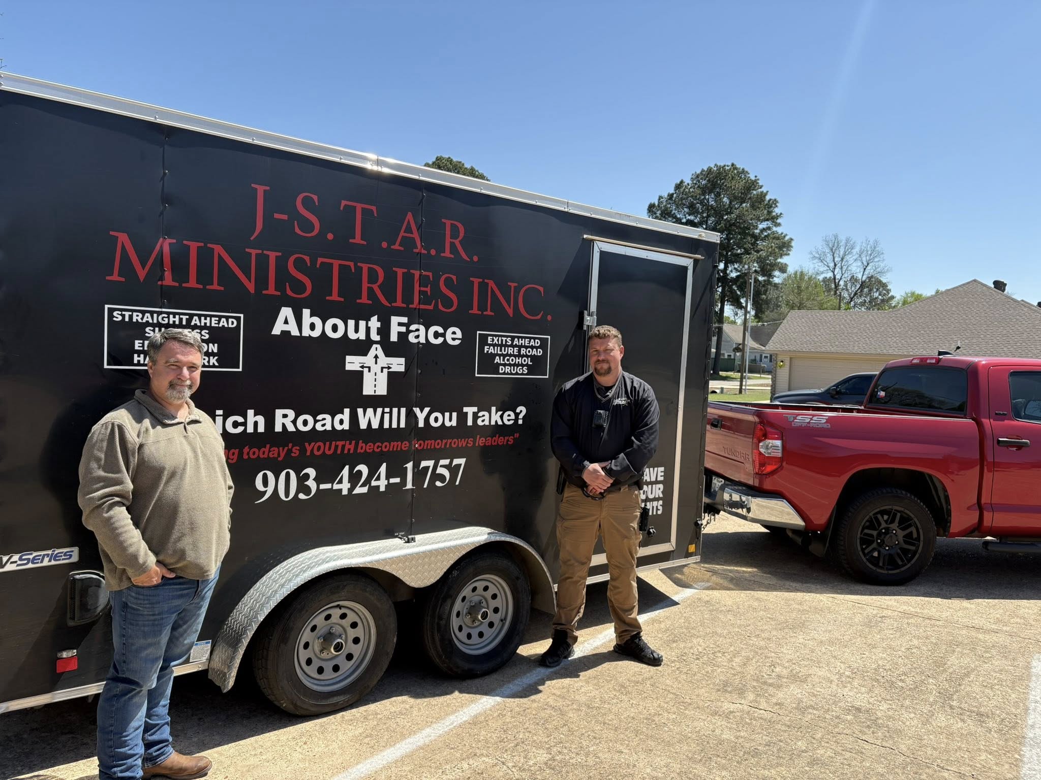 Community partners beside the J-STAR trailer during the Lake City tornado-relief run.