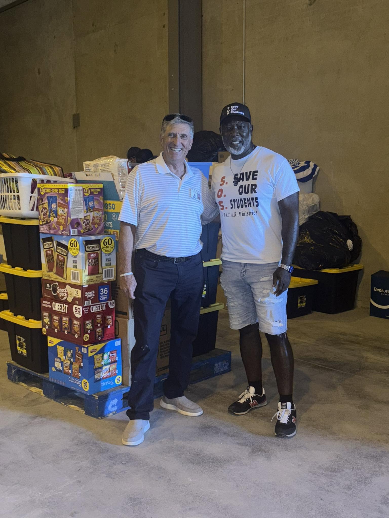 Patrick Johnson and a relief partner beside donated food and supplies during trip 71 to San Angelo
