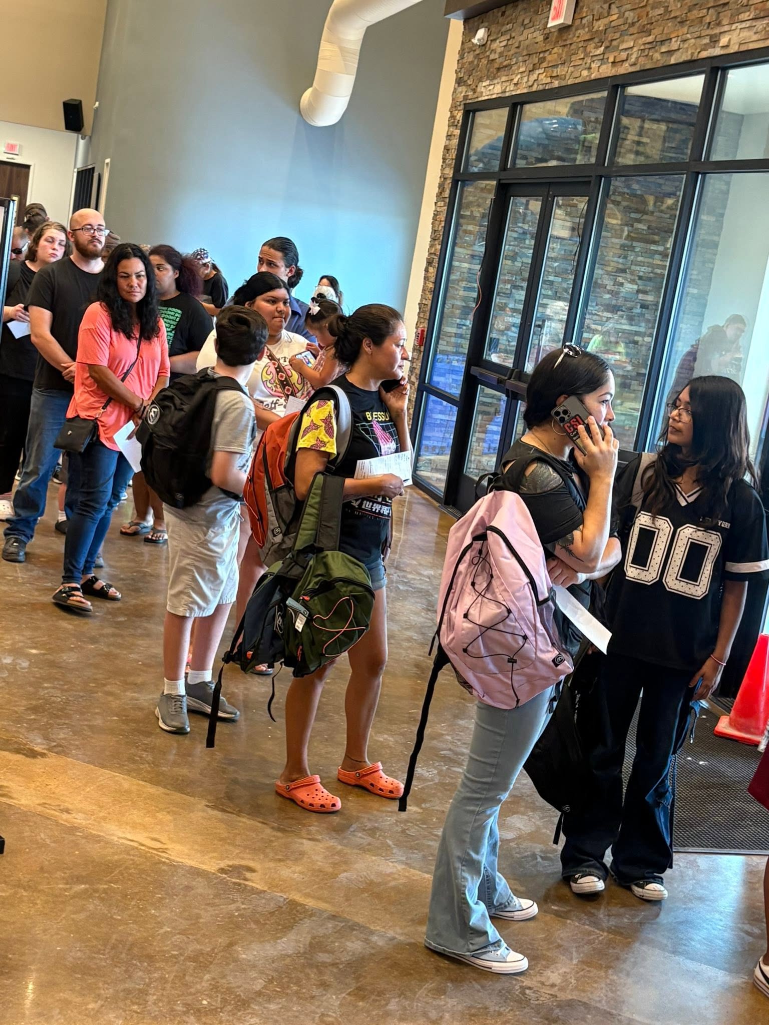 Children and families with backpacks at the San Angelo distribution during Trip #72.
