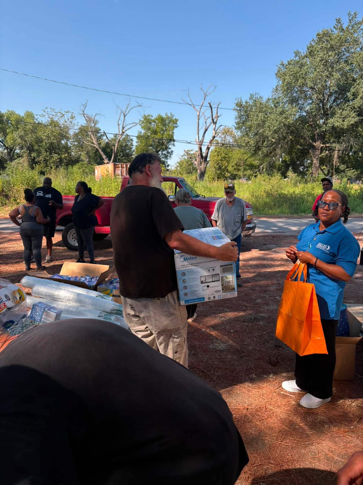 Neighbors and volunteers gather for the Sand Branch supply delivery.